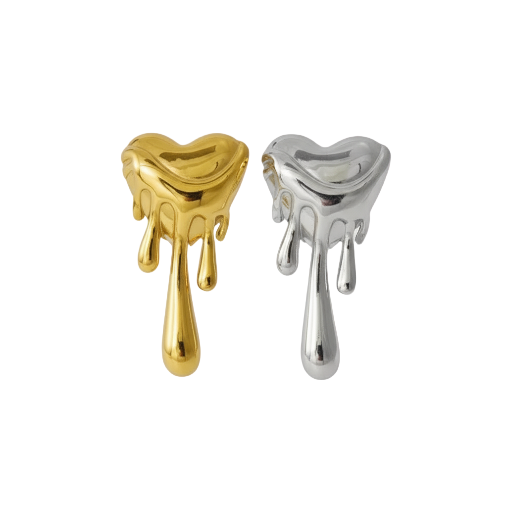 Gold and silver heart-shaped earrings on a light gray background