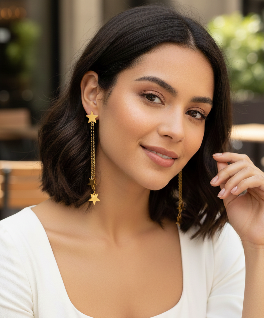 Woman wearing gold star earrings in an outdoor setting