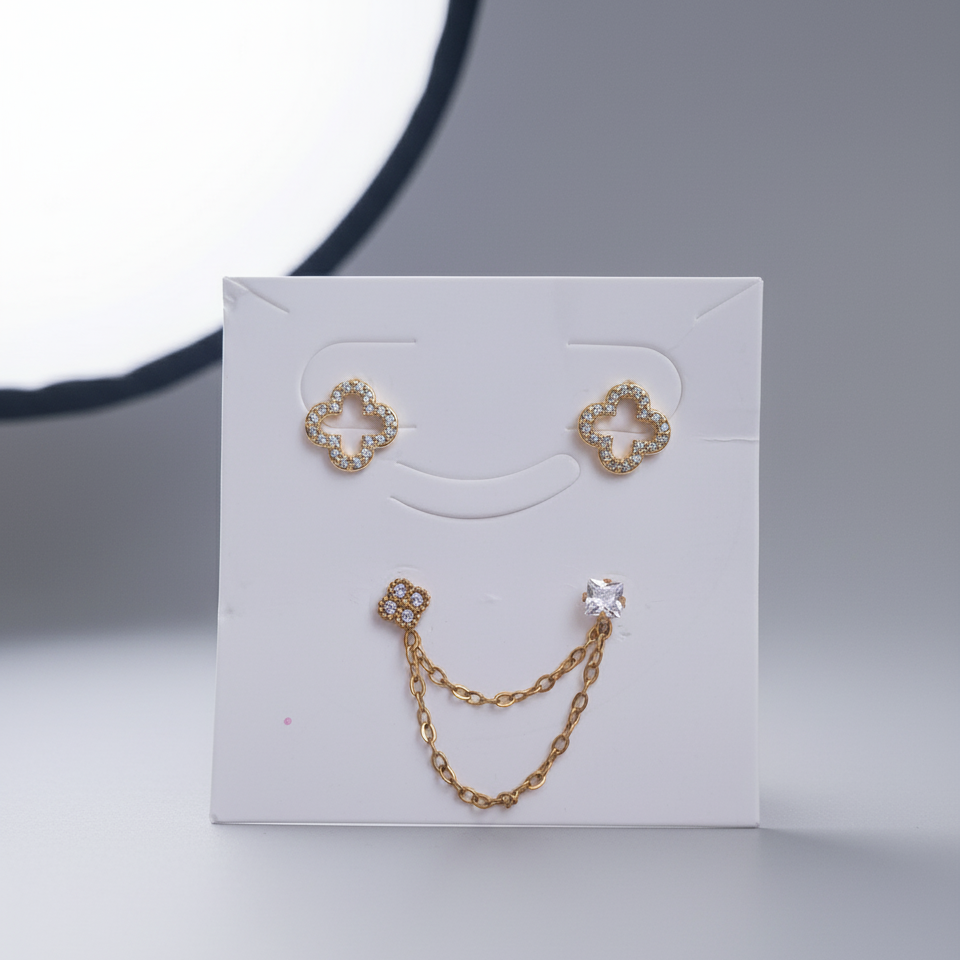 Gold chain earring set on a white card with a gray background