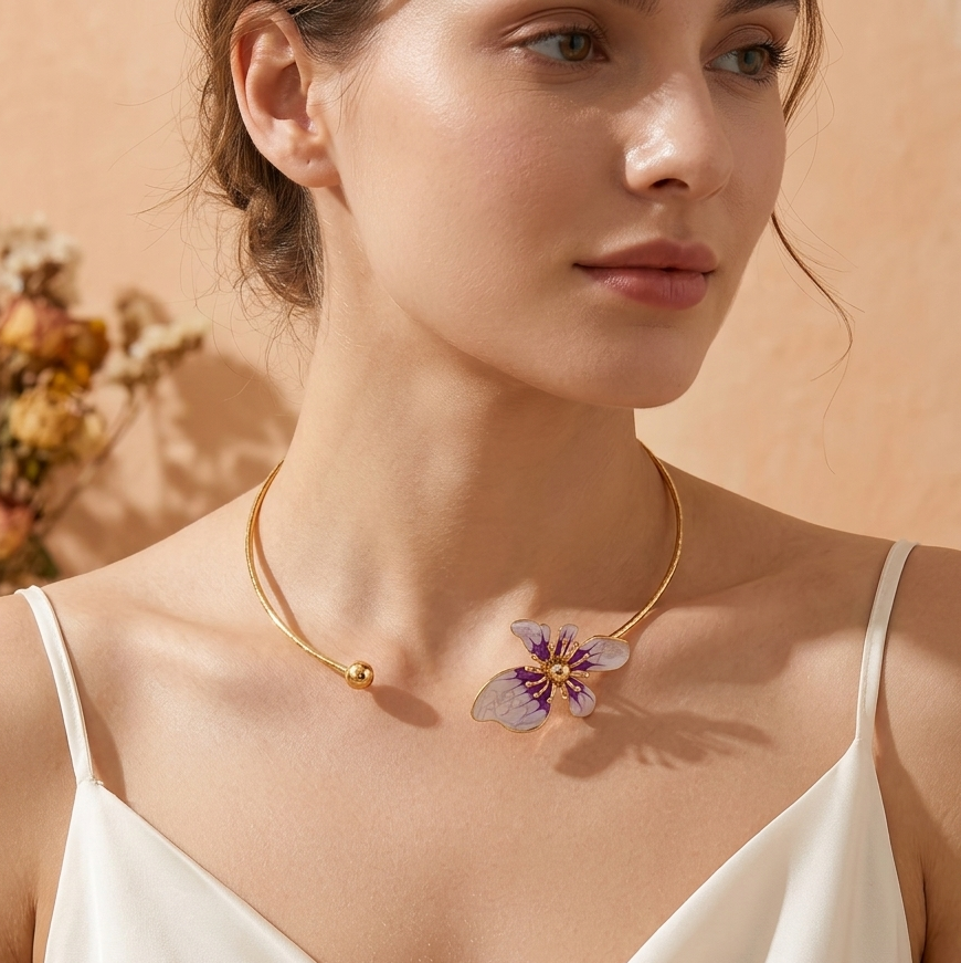 Woman wearing a gold necklace with a floral pendant against a beige background