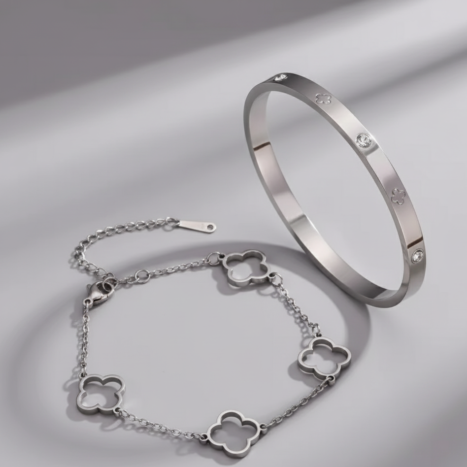 Silver bracelet with clover-shaped links on a light gray background