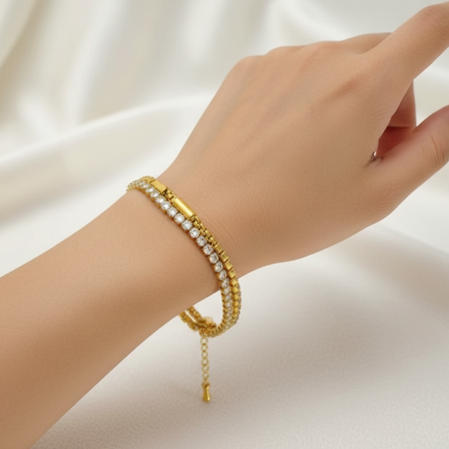 Hand wearing a gold bracelet on a white background