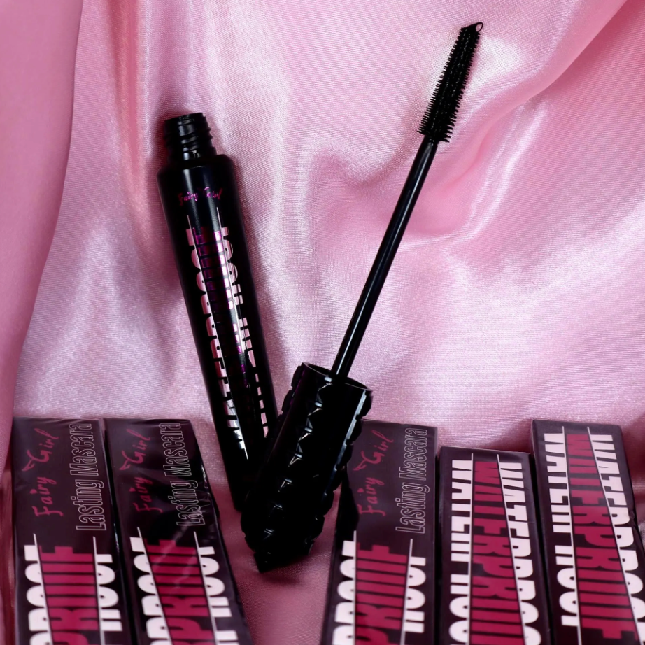 Mascara with packaging on a pink satin background