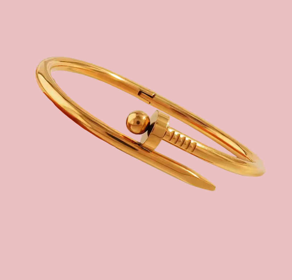 Gold bracelet on a beige background