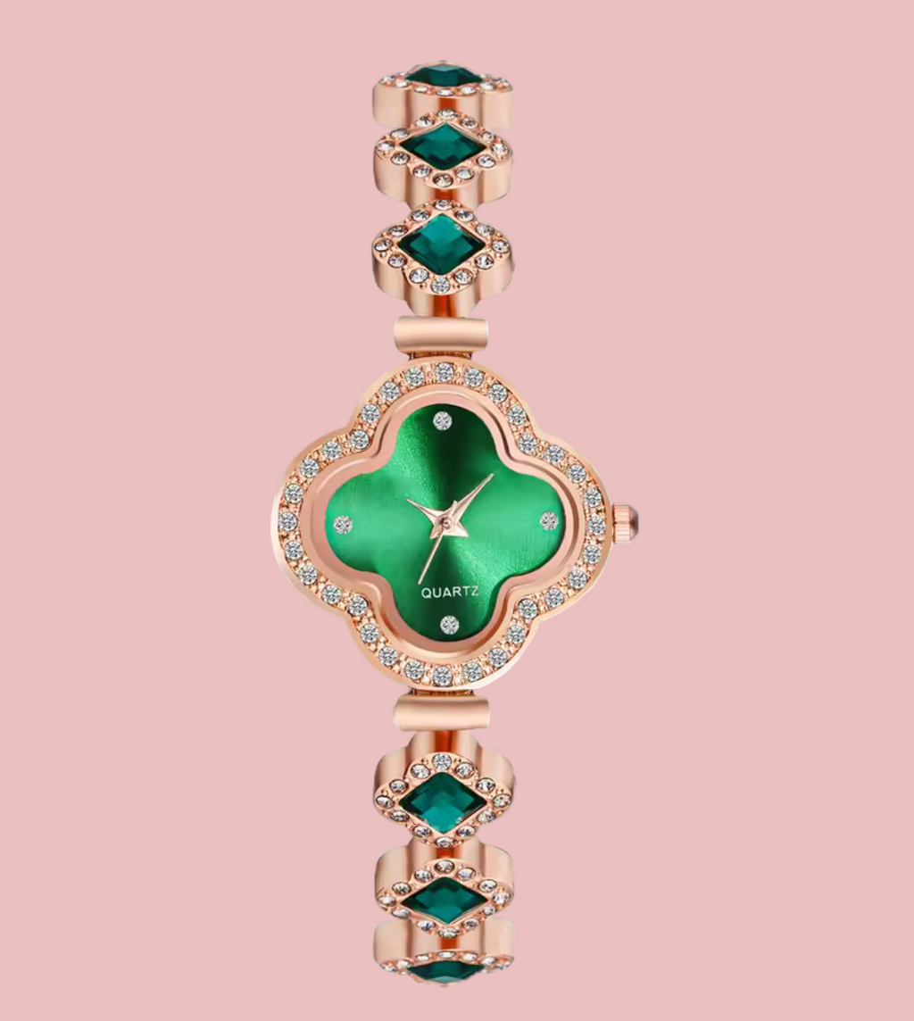 Green watch with rose gold case and band on a white background