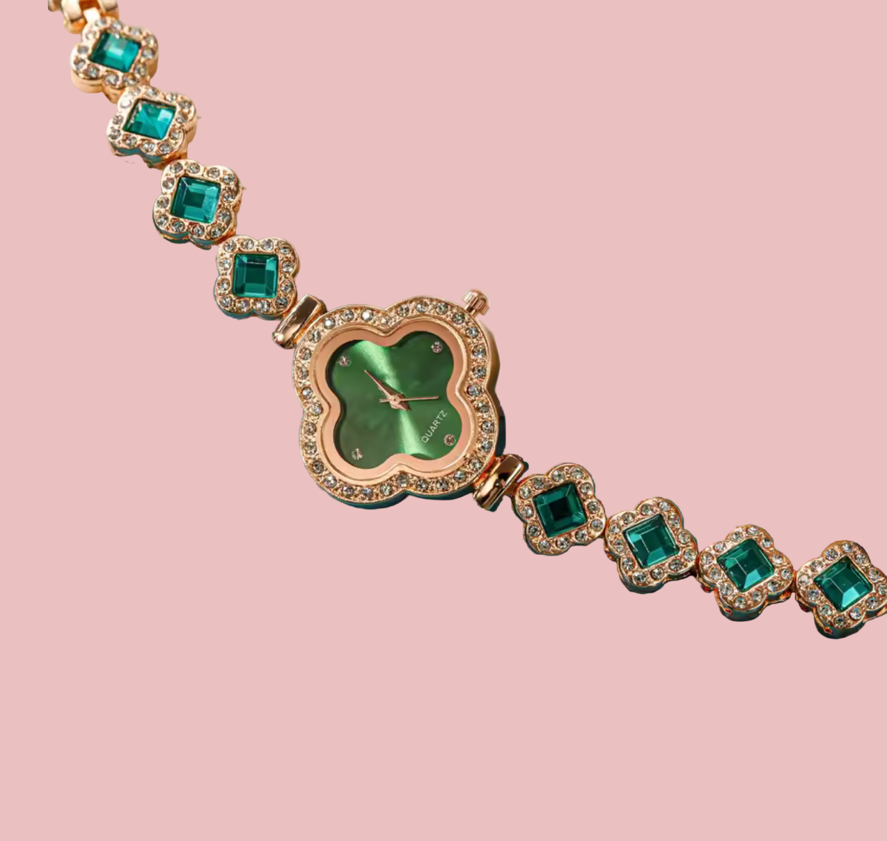 Jewelry set with emerald green stones on a blue surface