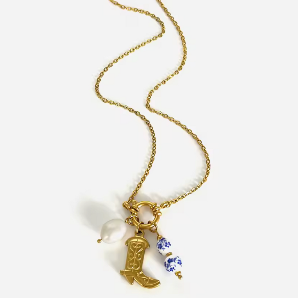 Necklace with cowboy boot and heart charm on a white background