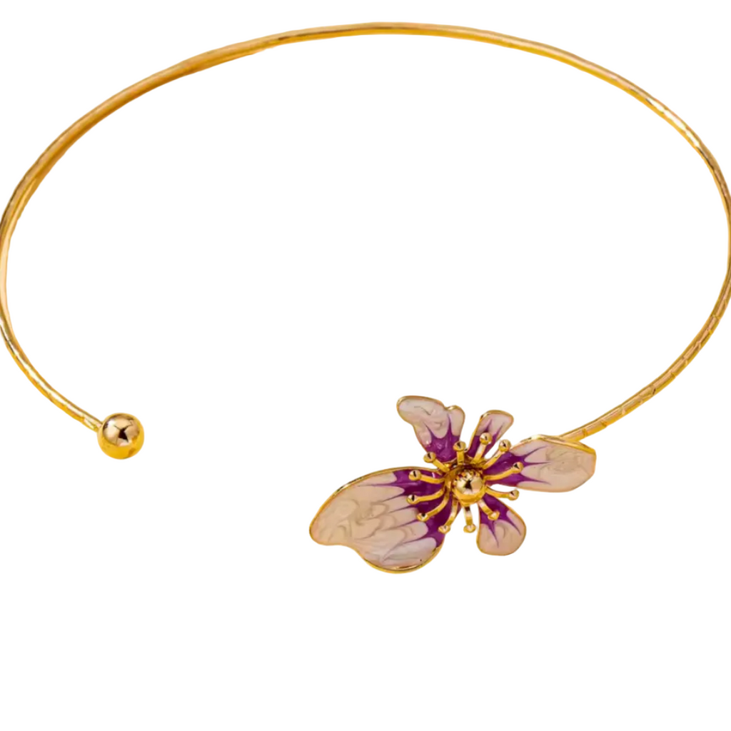 Gold necklace with a butterfly pendant on a beige background