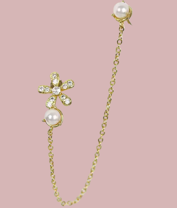 Gold chain earring with pearls and crystals on a white background
