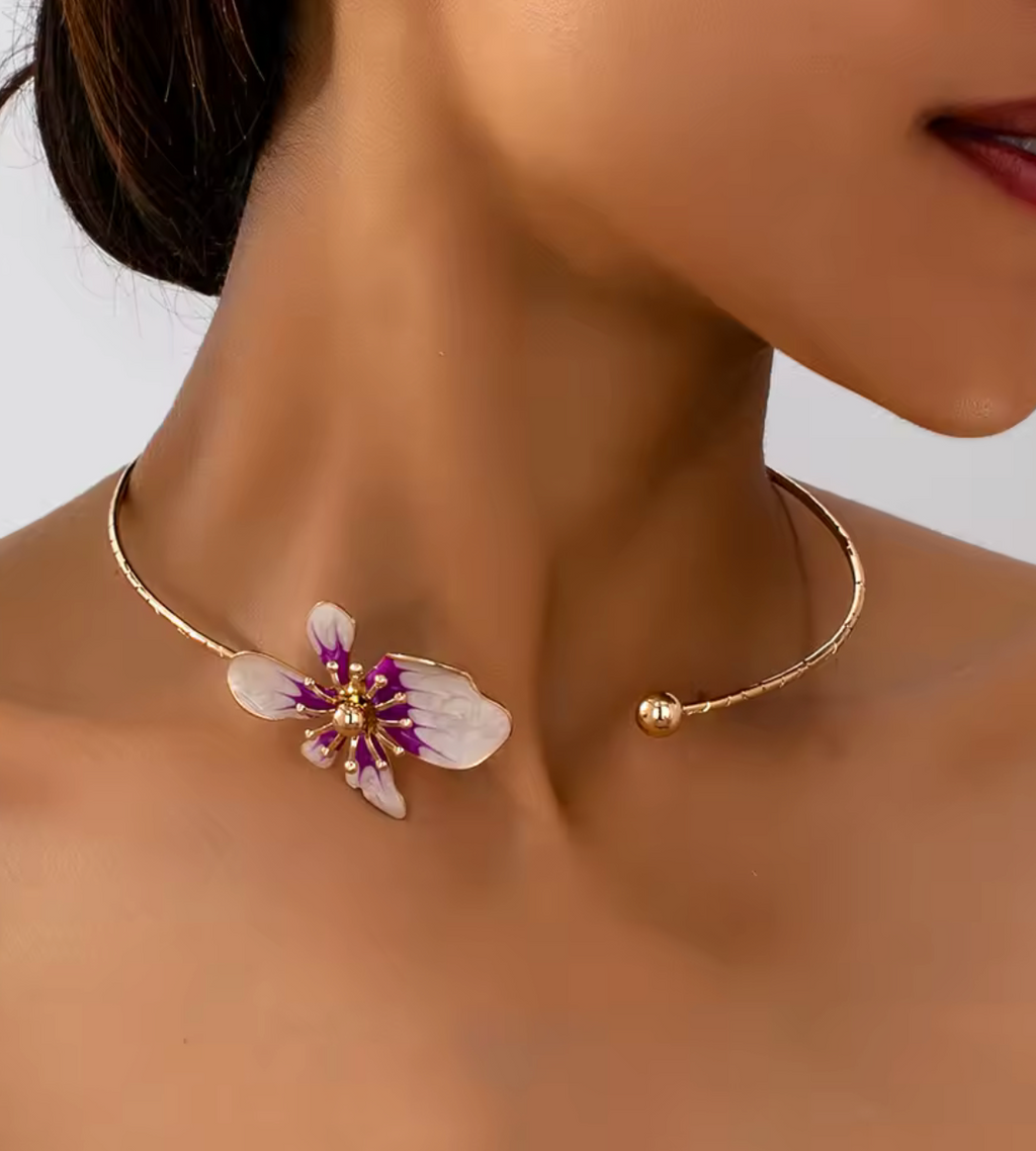 Gold necklace with a floral pendant worn by a model