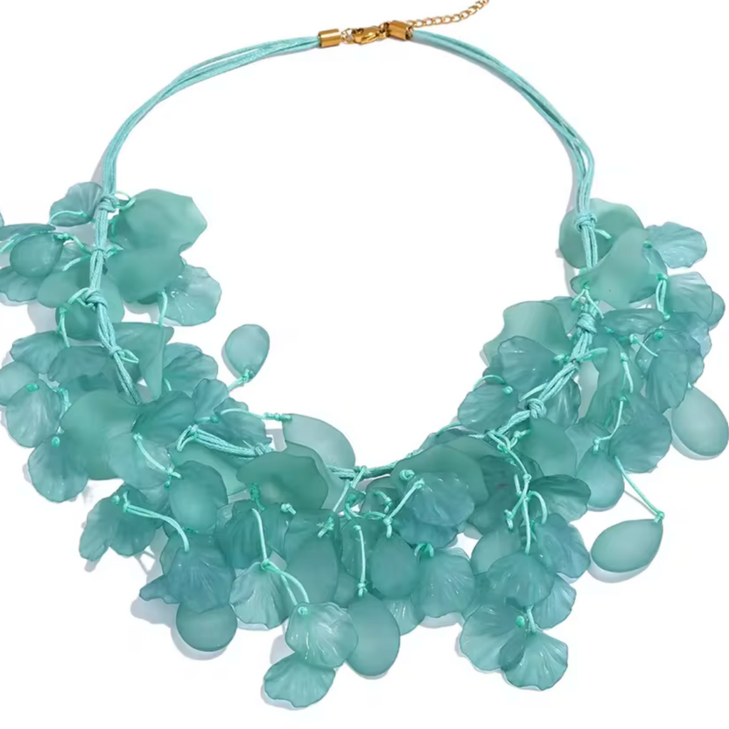 A light blue-green statement necklace featuring multiple layered, translucent teardrop-shaped beads on a thin cord with a gold clasp, shown against a plain white background.