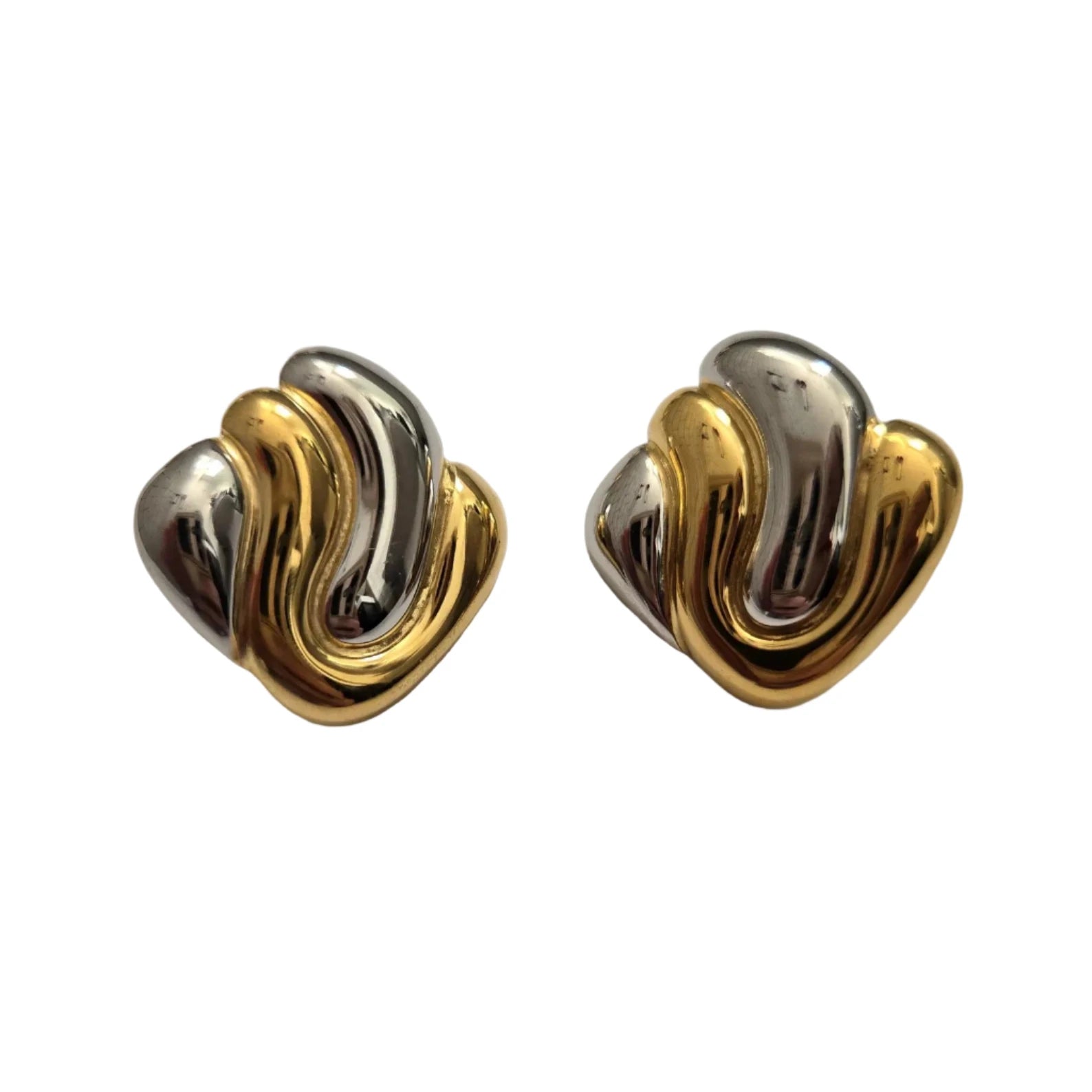 Pair of gold and silver earrings on a light gray background